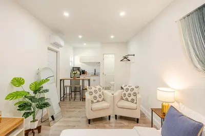 a living room with two chairs and a table at Miami North Beach in North Miami Beach