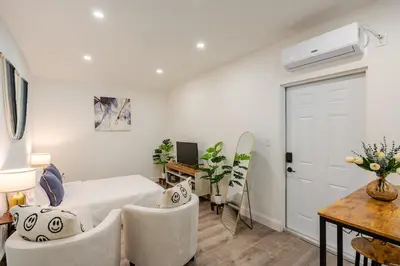a bedroom with a bed and a table and chairs at Miami North Beach in North Miami Beach