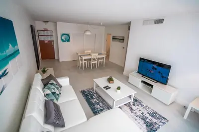 a living room with a white couch and a tv at Condo on the beach Hollywood 6th floor in Hollywood
