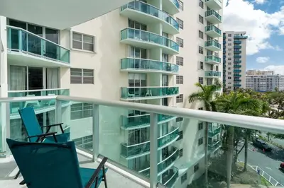 a balcony with two chairs and a building at Condo on the beach Hollywood 6th floor in Hollywood