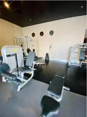 a gym with chairs and machines in a room at Beautiful studio in Beachwalk 2QB in Hallandale Beach