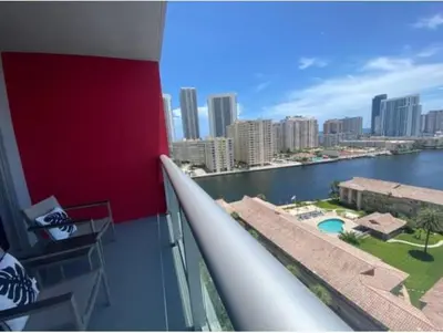 a balcony with a view of a city and the water at Beautiful studio in Beachwalk 2QB in Hallandale Beach