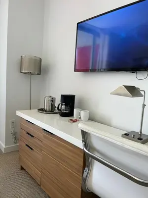 a flat screen tv hanging on a wall at Beautiful studio in Beachwalk 2QB in Hallandale Beach