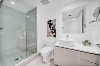a bathroom with a shower and a toilet and a sink at Beautiful Studio in Hallandale with Beach & Pool in Hallandale Beach