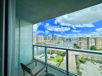 a balcony with a view of a river and buildings at Oceanview studio with Pool & Beach in Hallandale Beach