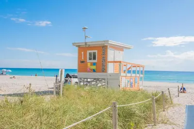 a small building on the beach near the ocean at Miami Apartment 2 full size beds & Beach Service in Hallandale Beach
