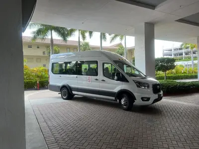 a small white van parked under a building at BeachWalk Studio Apmt 2 Beds w Beach Service in Hallandale Beach