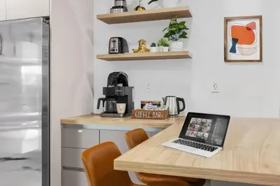 a kitchen with a wooden table with a laptop on it at 2BR, Families, Pets, Medical Stays, Hot Tub in Miami