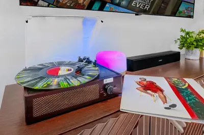 a record player sitting on a desk with a cd at 2BR, Families, Pets, Medical Stays, Hot Tub in Miami