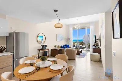 a kitchen and living room with a table and chairs at Stylish Nice Apt Hollywood Beach Boardwalk in Hollywood