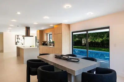 a kitchen and dining room with a table and chairs at Modern Luxury Home with Racket Sports Gym BBQ in Rockdale