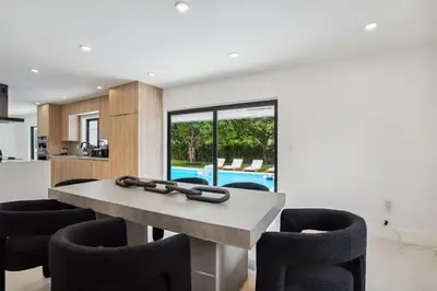 a kitchen and dining room with a table and chairs at Modern Luxury Home with Racket Sports Gym BBQ in Rockdale