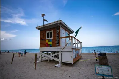 a lifeguard shack on a beach with the ocean at Miami Beach 1B 1B w Kitchen and Beach Service in Hallandale Beach