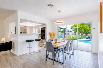 a kitchen and dining room with a table and chairs at Hard Rock Paradise in Andover Lakes Estates