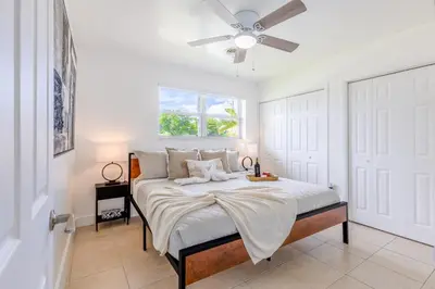 a bedroom with a bed with a ceiling fan at Hard Rock Paradise in Andover Lakes Estates