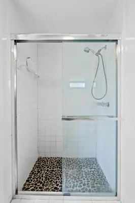 a shower with a glass door in a bathroom at Beach Home in Victoria Park in Fort Lauderdale