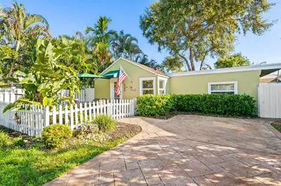 a house with a white picket fence at Beach Home in Victoria Park in Fort Lauderdale