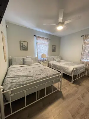 a bedroom with two beds and a ceiling fan at La Dolce Villa in Fort Lauderdale