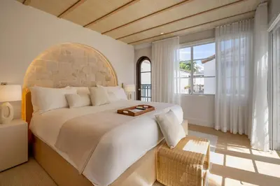 a bedroom with a large bed and a large window at Donatella Boutique Hotel in Miami Beach