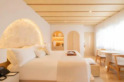a bedroom with a large white bed and a table at Donatella Boutique Hotel in Miami Beach
