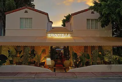 a building with a sign in front of it at Donatella Boutique Hotel in Miami Beach