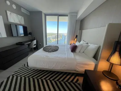 a bedroom with a large white bed and a large window at Best Apartment next to Hollywood Beach 2B 2B in Hollywood
