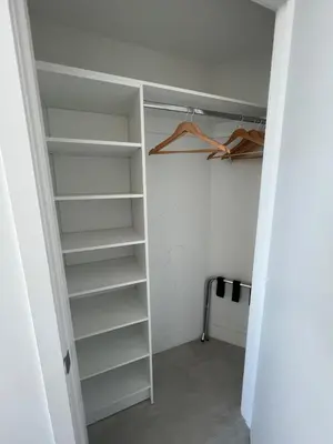 a closet with white shelves in a room at Best Apartment next to Hollywood Beach 2B 2B in Hollywood