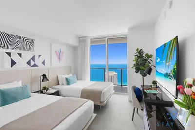 a hotel room with two beds and a view of the ocean at Bay View 2Br Apartment with Amenities in Hollywood