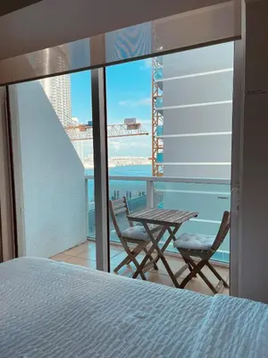 a bedroom with a bed and a table and chairs at BrickellRiver LOFT with parking & 12 min to South Beach in Miami