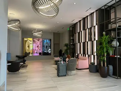 a lobby with chairs and tables in a building at Apt Hyde, Beach, Pool, and Resort Amenities in Miami in Hollywood