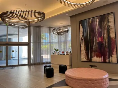 a living room with a round table and two chandeliers at Hyde Luxury 2 Bedroom Apartment in Miami Beach and Pool in Hollywood