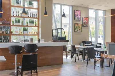 a bar in a restaurant with tables and chairs at Studio 2b 1b with Beach and Pool Miami Beach in Hallandale Beach