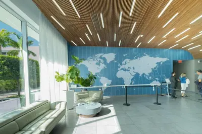 a lobby with a blue wall with a map of the world at Amazing Studio at Hallandale Beach with service beach in Hallandale Beach
