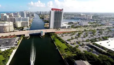 an aerial view of a city with a bridge over a river at Comfy Apt 2 Queen Beds with Pool & Beach in Hallandale Beach