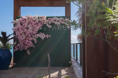 a bunch of pink flowers hanging on a fence at Comfy Apt 2 Queen Beds with Pool & Beach in Hallandale Beach