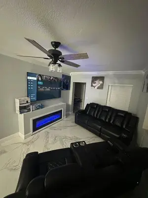 a living room with a couch and a ceiling fan at Luxury Entertainment home Hard rock stadium in Opa-locka
