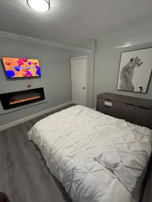 a bedroom with a bed and a tv on the wall at Luxury Entertainment home Hard rock stadium in Opa-locka