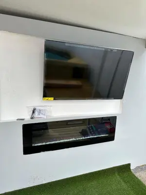 a flat screen tv hanging on a wall at Luxury Entertainment home Hard rock stadium in Opa-locka