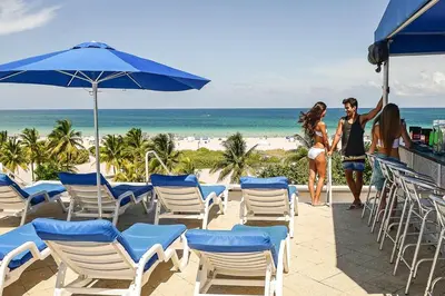 a man and a woman are standing on the beach at Amazing 1 Bedroom with Rooftop Pool D309 in Miami Beach