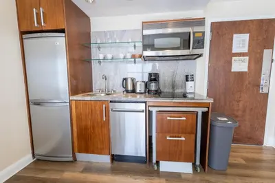 a small kitchen with a sink and a refrigerator at Amazing 1 Bedroom with Rooftop Pool D304 in Miami Beach