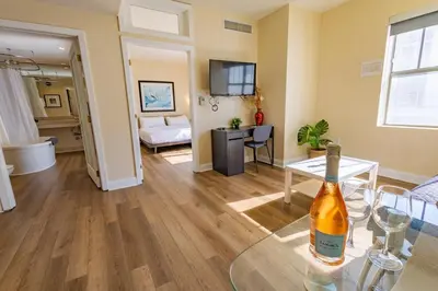 a living room with a bottle of wine on a glass table at Amazing 1 Bedroom with Rooftop Pool D304 in Miami Beach