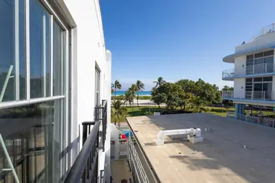 a balcony of a building with a view of the ocean at Amazing 1 Bedroom with Rooftop Pool D304 in Miami Beach