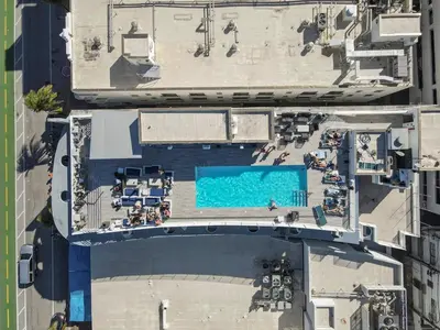 an overhead view of a swimming pool and the ocean at Beautiful 1 bedroom with Rooftop Pool D209 in Miami Beach