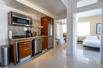 a room with a kitchen and a bedroom with a bed at Beautiful 1 bedroom with Rooftop Pool D209 in Miami Beach