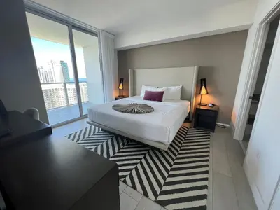 a bedroom with a bed and a large window at Best Apartment next to Hollywood Beach 2B 2B in Hollywood