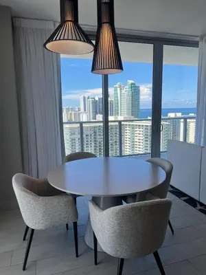 a dining table and chairs in a room with a window at Best Apartment next to Hollywood Beach 2B 2B in Hollywood