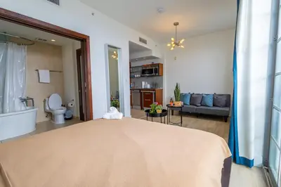 a bedroom with a bed and a living room at Studio with rooftop pool on Ocean Dr B303 in Miami Beach
