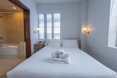 a bedroom with a white bed with towels on it at Beautiful Studio with Rooftop pool B309 in Miami Beach