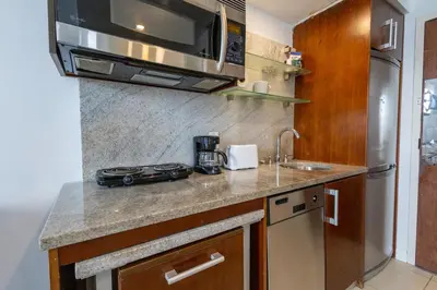 a kitchen with a sink and a microwave at Beautiful Studio with Rooftop pool B309 in Miami Beach