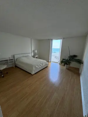 a bedroom with a bed and a wooden floor at beautiful place 1 in Hollywood